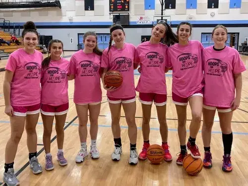 Group of girls wearing a basketball Uniform 